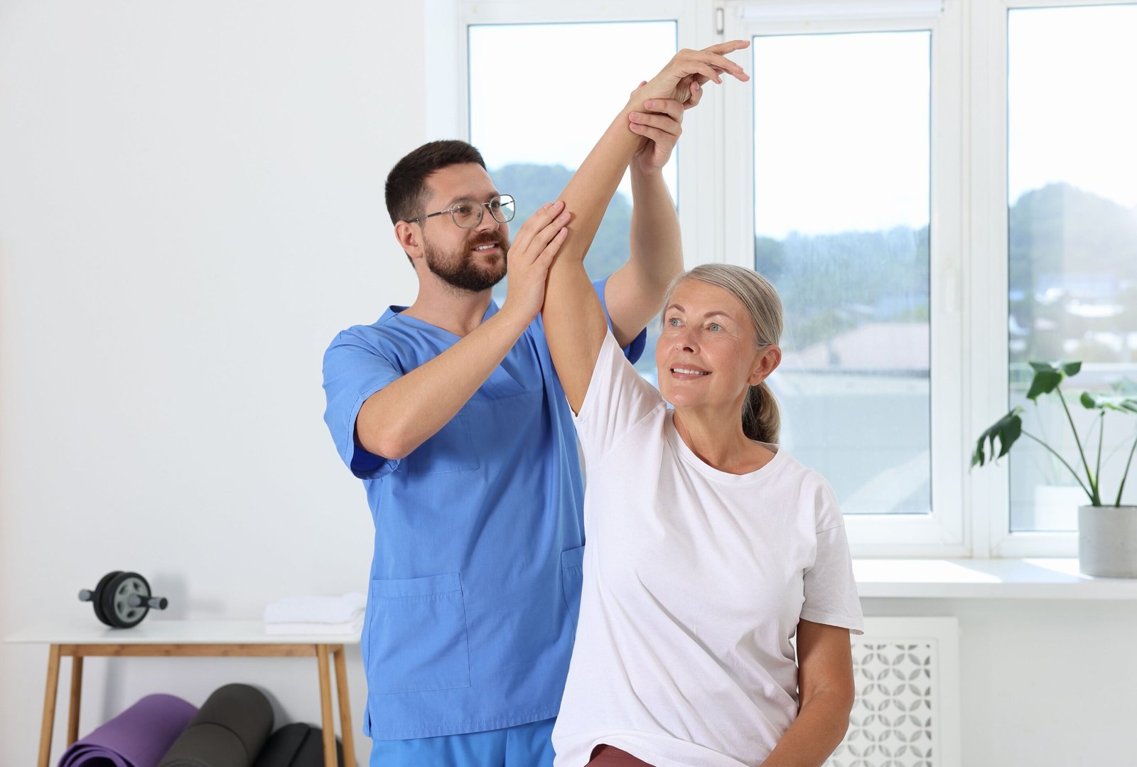 Specialist physiotherapist assessing a perimenopausal patient’s lower back at a central London clinic Specialist physiotherapist assessing a perimenopausal patient's lower back at a central London clinic