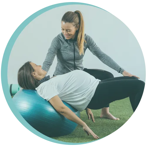 Pregnant woman doing physiotherapy exercises with physiotherapist