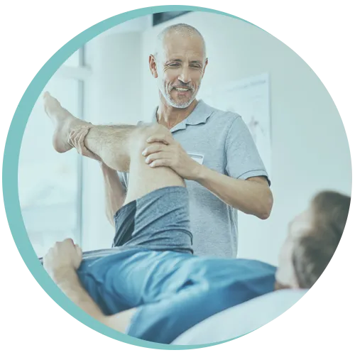 Physiotherapist treating male patient for sports injury rehabilitation
