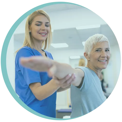 Physiotherapist assisting woman with shoulder mobility exercise