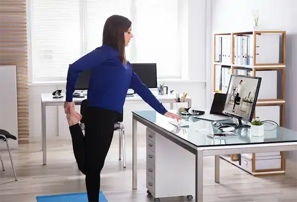 Online physiotherapy exercises during a telehealth consultation Woman following a physiotherapy exercise during an online telehealth session at home