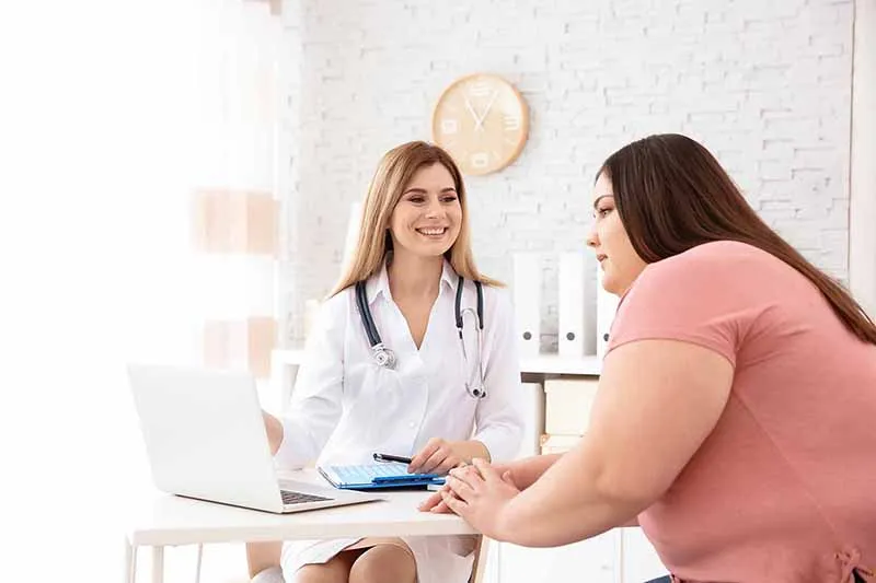 Frequent Urination in Women Assessment at PhysioReform London Woman speaking with a female clinician about frequent urination and pelvic floor symptoms at a London physiotherapy clinic